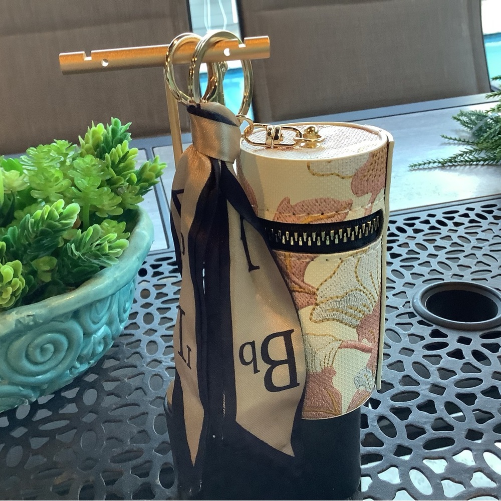 NWT, bag charm with storage and ribbon.